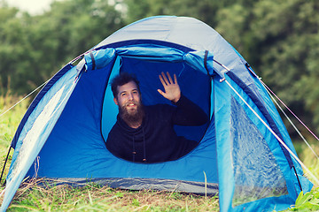 Image showing smiling male tourist with beard in tent