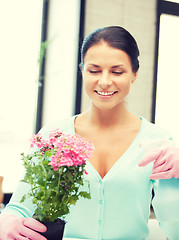 Image showing lovely housewife with flower