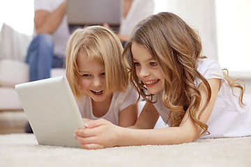 Image showing happy little girls with tablet pc computer at home