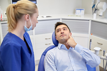 Image showing male dentist with woman patient at clinic