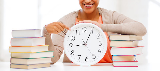 Image showing attractive woman with white clock