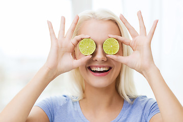 Image showing happy woman having fun covering eyes with lime