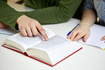 Image showing close up of students hands with book or textbook