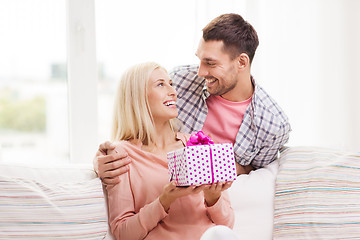 Image showing happy man giving woman gift box at home