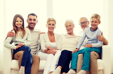 Image showing happy family sitting on couch at home