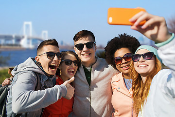 Image showing happy friends taking selfie with smartphone