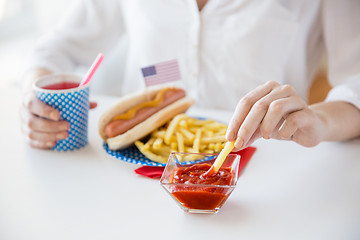 Image showing close up of woman eating on american food