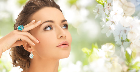 Image showing close up of woman with cocktail ring and earrings