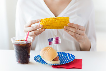 Image showing woman hands holding corn with hot dog and cola