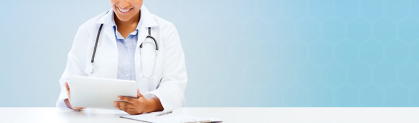 Image showing happy african doctor with tablet pc over blue