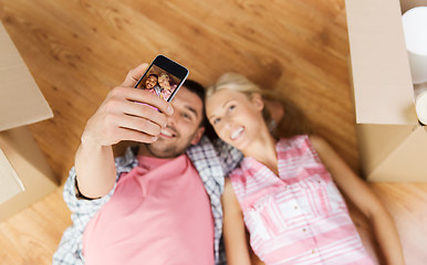 Image showing couple with big cardboard boxes moving to new home