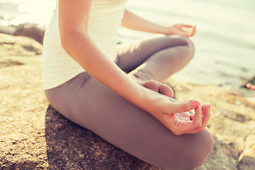 Image showing close up of woman making yoga exercises outdoors