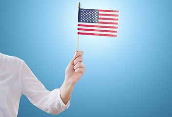 Image showing close up of woman holding american flag in hand