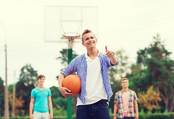 Image showing group of smiling teenagers playing basketball