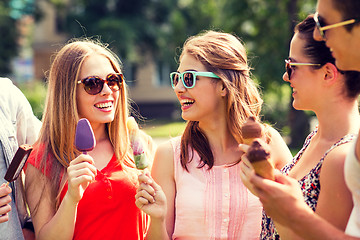 Image showing group of smiling friends with ice cream outdoors