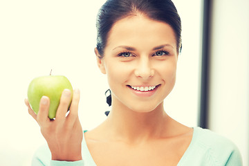 Image showing lovely housewife with green apple