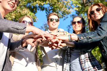 Image showing close up of teenage friends with hands on top