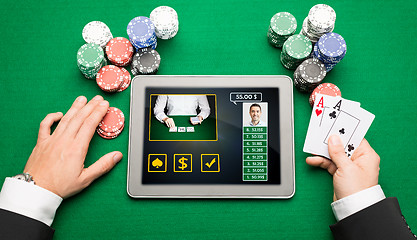 Image showing casino player with cards, tablet pc and chips