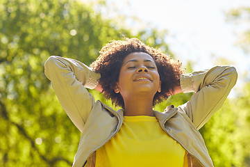 Image showing happy african american young woman in summer park