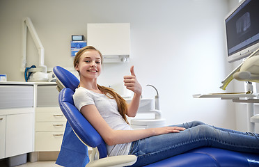 Image showing happy patient girl showing thumbs up at clinic