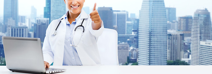 Image showing african female doctor with laptop shows thumbs up