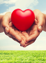 Image showing womans cupped hands showing red heart