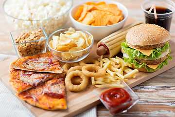 Image showing close up of fast food snacks and drink on table