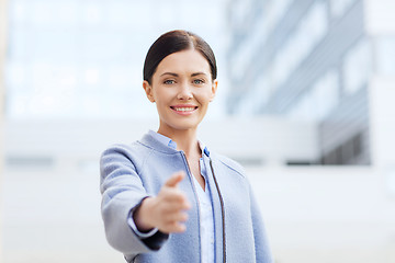 Image showing smiling businesswoman giving hand for handshake