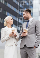 Image showing smiling businessmen with paper cups outdoors