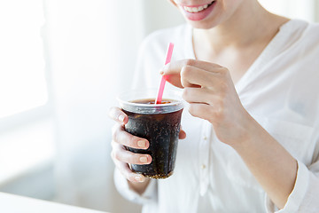 Image showing close up of happy woman drinking coca cola