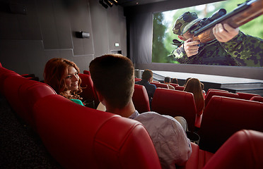 Image showing happy couple watching movie and talking in theater