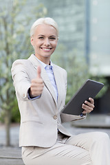 Image showing smiling businesswoman with tablet pc outdoors