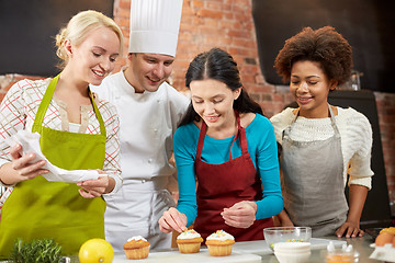 Image showing happy women and chef cook baking in kitchen