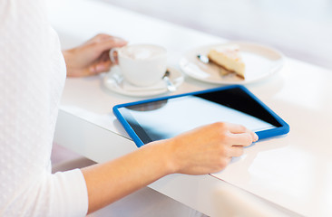 Image showing close up of woman with tablet pc drinking coffee