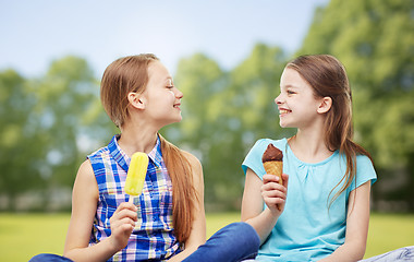 Image showing happy little girls eating ice-cream in summer park