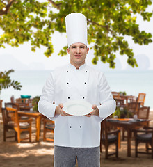 Image showing happy male chef cook showing empty plate