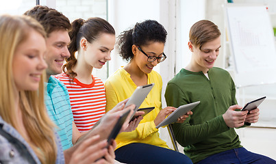 Image showing smiling students with tablet pc at school