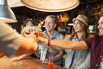 Image showing happy friends drinking beer at bar or pub