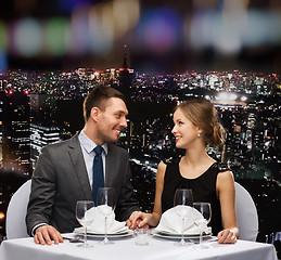 Image showing smiling couple looking at each other at restaurant