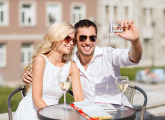 Image showing couple taking photo in cafe