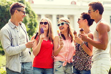 Image showing group of smiling friends with ice cream outdoors