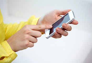 Image showing close up of female hands with smartphone at home