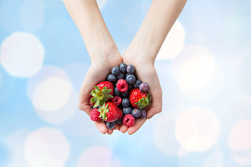 Image showing close up of woman hands holding berries