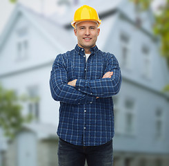 Image showing smiling male builder or manual worker in helmet