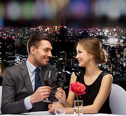 Image showing young couple with glasses of wine at restaurant