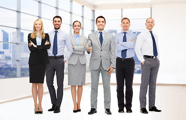 Image showing group of smiling businessmen making handshake