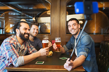 Image showing friends taking selfie and drinking beer at bar