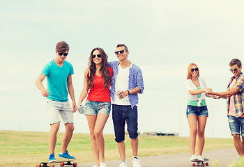 Image showing group of smiling teenagers with skateboards