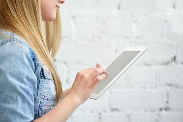 Image showing close up of female hands with tablet pc on stairs