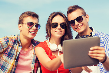 Image showing group of smiling friends with tablet pc outdoors